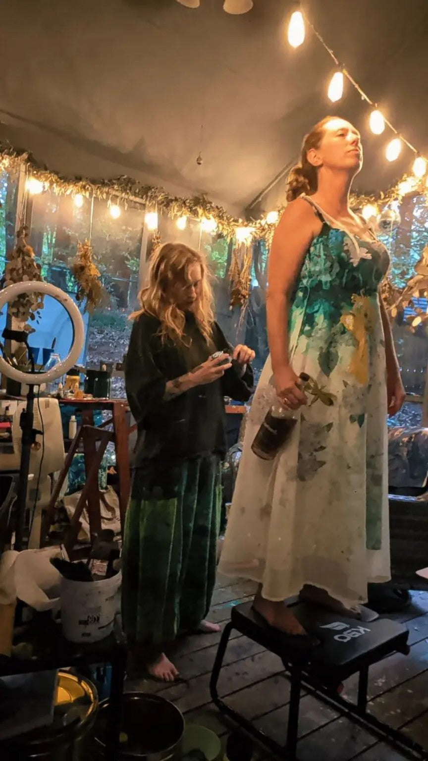 Behind the scenes on the porch while Patricia Graham and her team paint a wearable-art dress for Venice