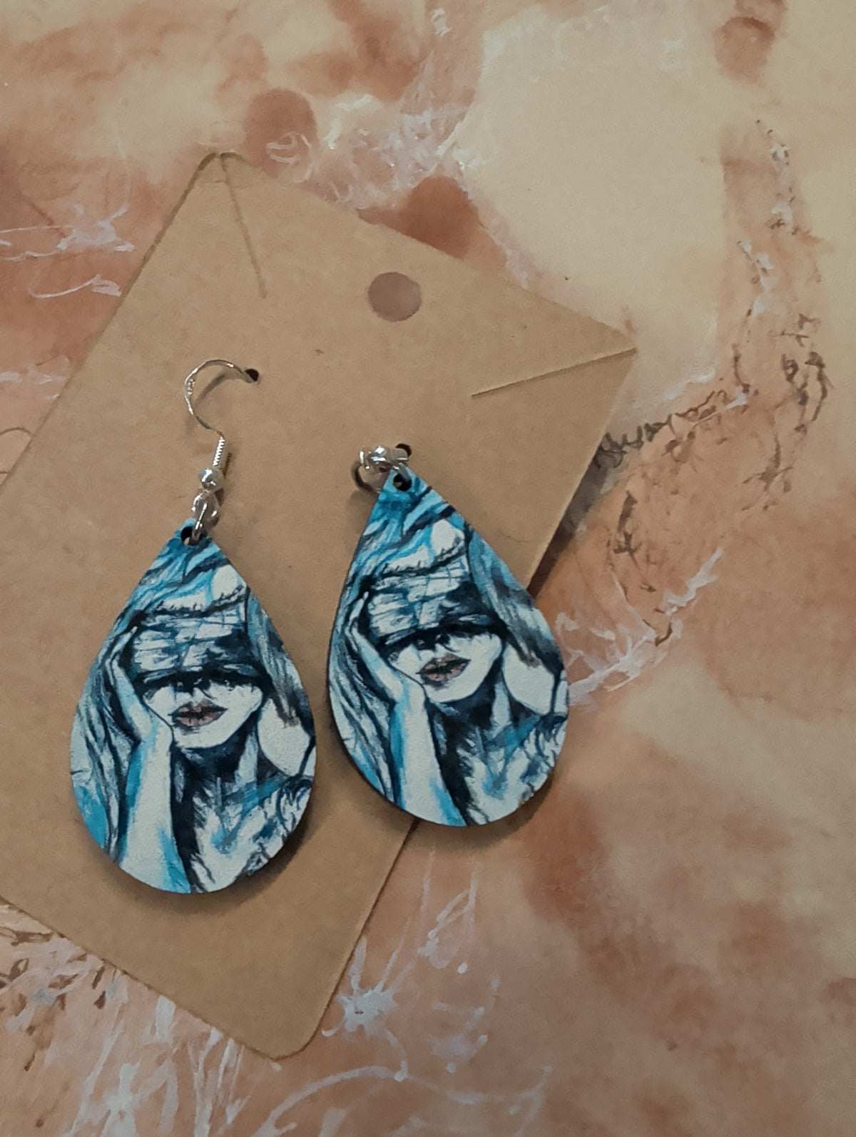 Ourea Luna wearable art earrings featuring Unseen and Wild Woman Rising artwork